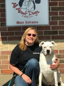 A woman and her dog pose for the camera.