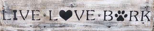 A wooden sign that says love with a heart.