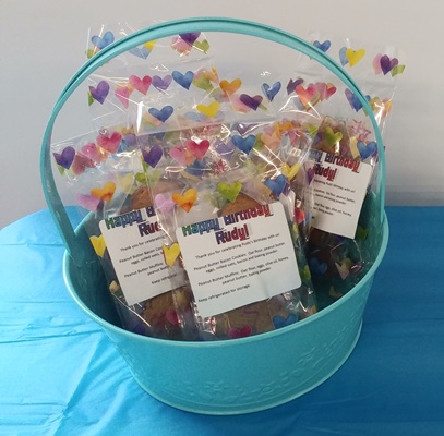 A blue bucket with some different colored butterflies in it