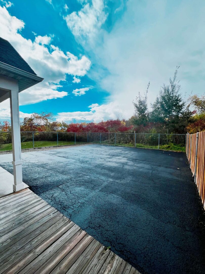 A patio with a wooden deck and a sky background