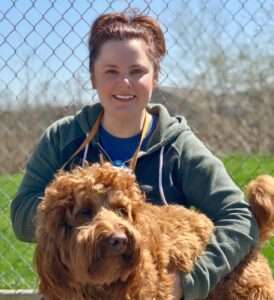 A woman holding a dog in her arms.