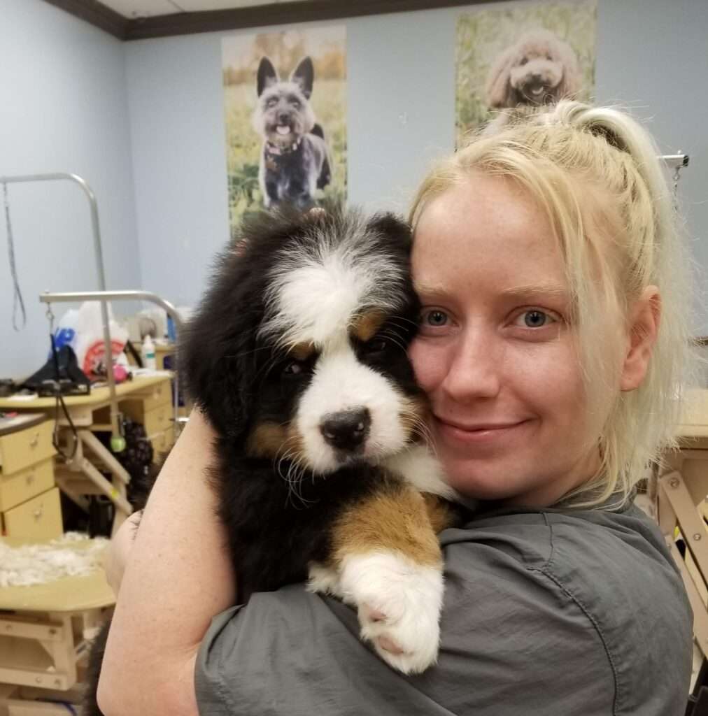 A woman holding a dog in her arms.