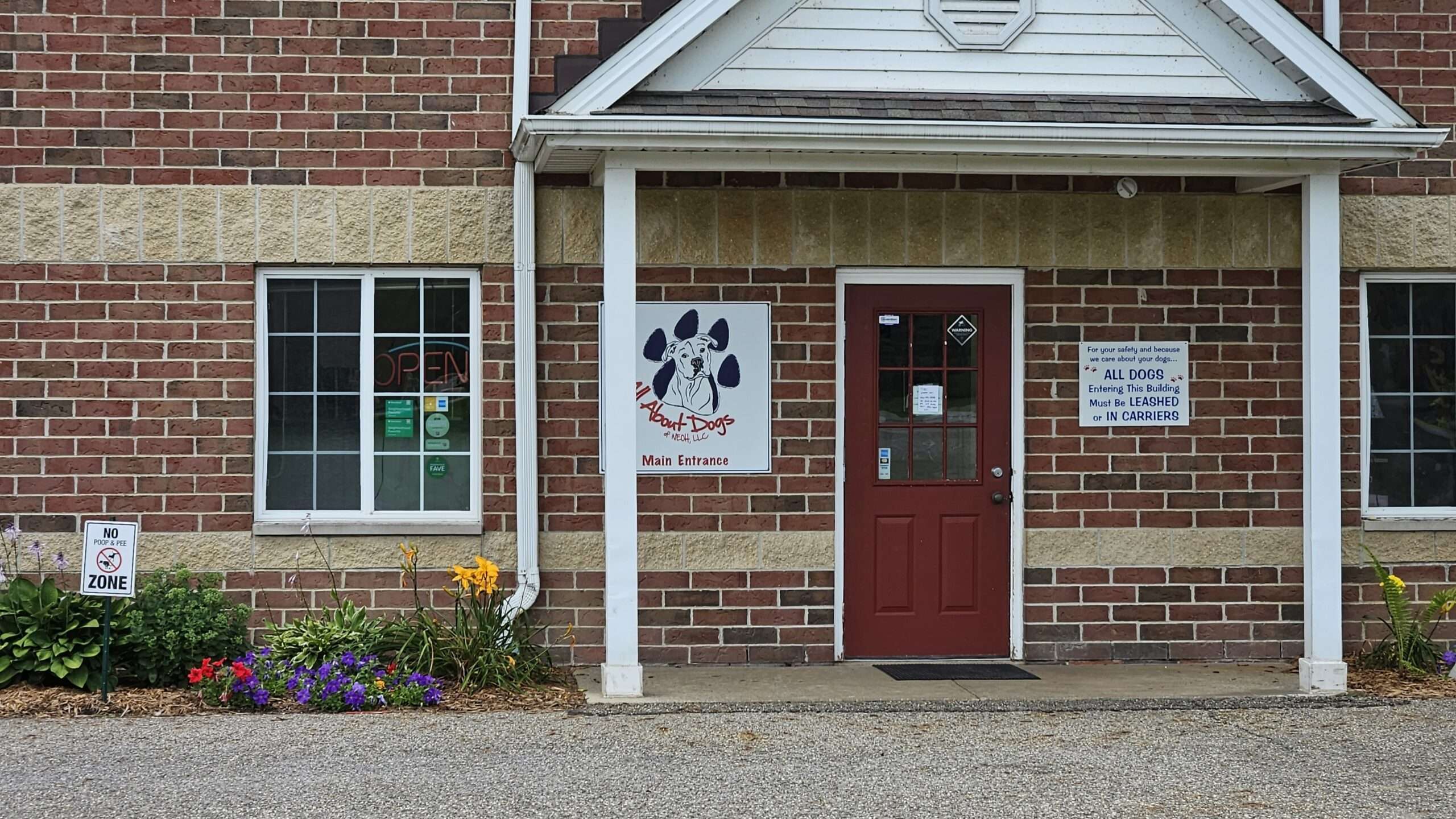 A red door and white sign on the side of a building.